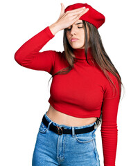 Young brunette teenager wearing french look with beret surprised with hand on head for mistake,...