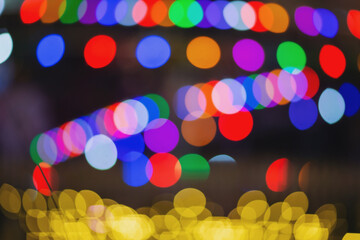 Abstract bokeh night in city background. New Year blurry walpaper. huge garland on the eve of the...