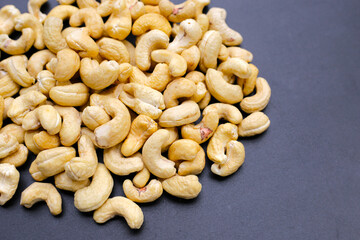 Cashew nuts on dark background.