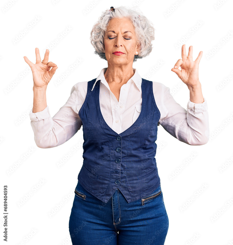 Wall mural Senior grey-haired woman wearing casual clothes relax and smiling with eyes closed doing meditation gesture with fingers. yoga concept.