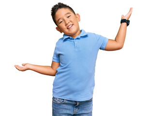 Little boy hispanic kid wearing casual clothes clueless and confused expression with arms and hands...