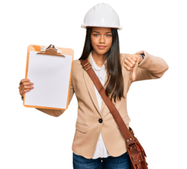 Beautiful hispanic woman architect showing black space on clipboard with angry face, negative sign showing dislike with thumbs down, rejection concept