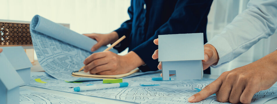 Worker, architect and engineer work on real estate construction project oratory planning with cartography and cadastral map of urban town area to guide to construction developer business plan of city