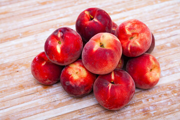Fototapeta na wymiar Closeup of whole ripe red peaches on wooden table. Vitamin fruits