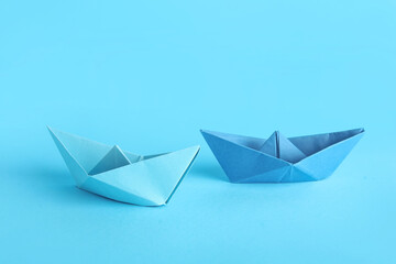 Origami boats on blue background