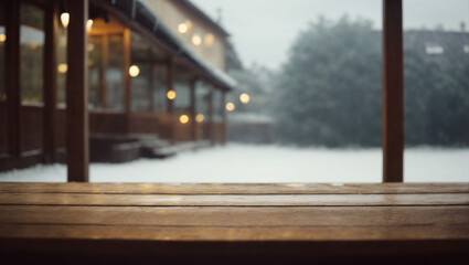 An empty wooden table with the snowy backyard of a house in the background during winter. Beginning of the year concept. - obrazy, fototapety, plakaty