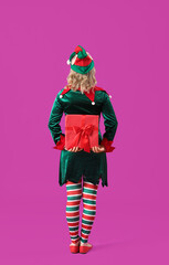 Woman dressed as elf with Christmas gift on purple background - obrazy, fototapety, plakaty