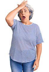 Senior woman with gray hair wearing casual striped clothes surprised with hand on head for mistake, remember error. forgot, bad memory concept.