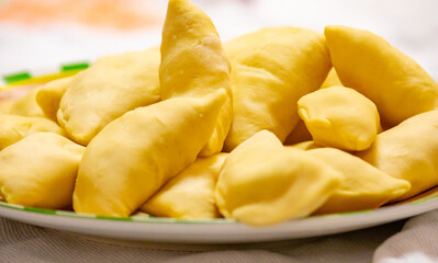 Verenik, pierogi, pierogui, perohê, Ukrainian food closeup on wooden table with wheat flour and...