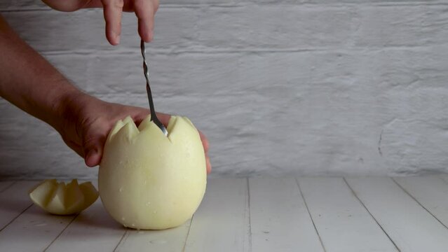 Melon with wine, melvin white, video, preparing, cocktail, stir. On white wooden table, stirrer. Originally from Chile, summer. Typical Chilean food and drink