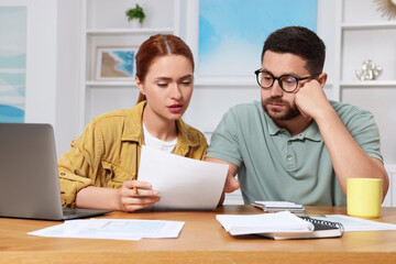 Couple doing taxes at table in room