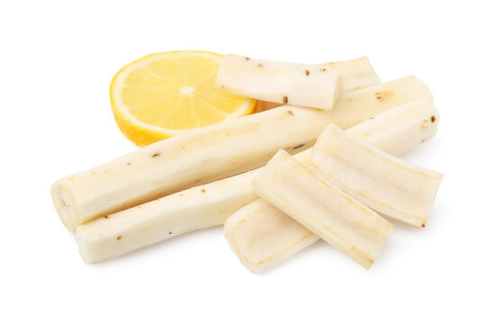 Cut raw salsify roots and lemon isolated on white