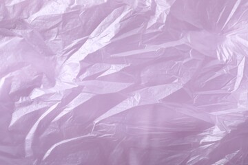 Texture of violet plastic bag as background, closeup