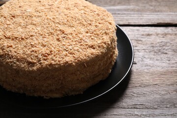 Delicious Napoleon cake on wooden table, closeup. Space for text