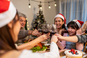 Asian lovely family celebrating Christmas party together in house. 