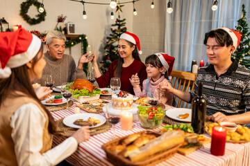 Asian lovely family celebrating Christmas party together in house. 