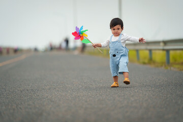 infant baby learning to walking first step on pathway - obrazy, fototapety, plakaty