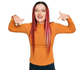 Young caucasian woman wearing casual clothes looking confident with smile on face, pointing oneself...