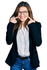 Young caucasian girl wearing business style and glasses smiling with open mouth, fingers pointing and forcing cheerful smile