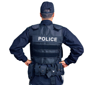 Young hispanic man wearing police uniform standing backwards looking away with arms on body