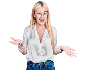 Beautiful blonde woman wearing elegant shirt and glasses smiling cheerful with open arms as friendly welcome, positive and confident greetings