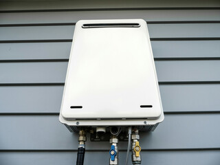Modern external continuous flow gas water heater mounted on house wall