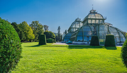 Large greenhouse in garden. - obrazy, fototapety, plakaty