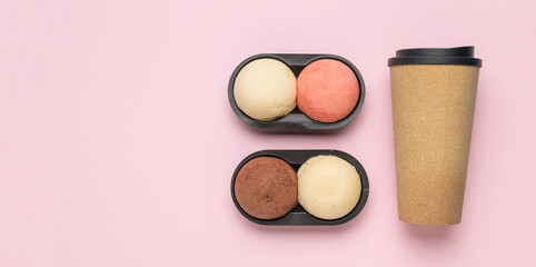 Coffee with colorful cakes on a pink background. A place for your text.