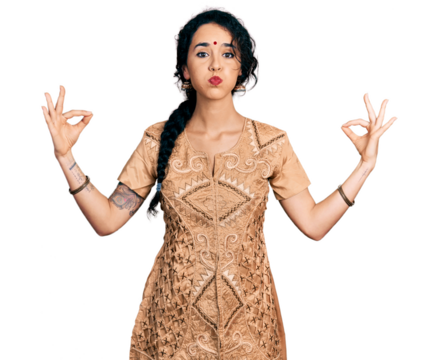 Young indian woman doing gyan mudra puffing cheeks with funny face. mouth inflated with air, catching air.