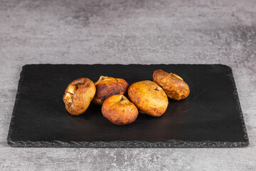 Grilled portobello mushrooms on black  plate, .Brown champignon portobello mushrooms