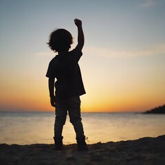 Fototapeta premium Silhouette shot of a child standing against a bright background, with their hand raised