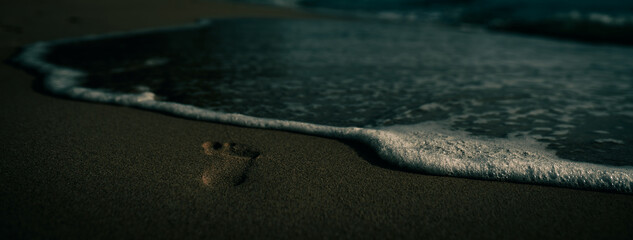 Dark foot print on the beach 