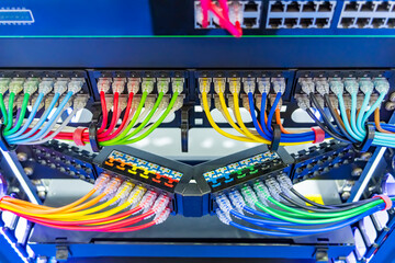 Network panel, switch and colorful cable in data center - obrazy, fototapety, plakaty