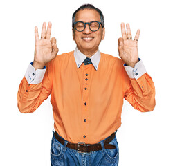 Middle age indian man wearing casual clothes and glasses relax and smiling with eyes closed doing meditation gesture with fingers. yoga concept.