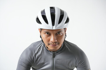 Portrait of a young Asian man using a helmet bike.  Isolated on a white background. Travel and sport concept.