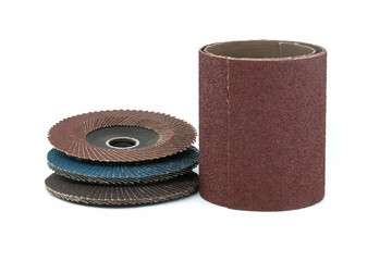Pile of abrasive discs and sandpaper over white