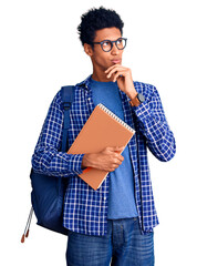 Young african american man wearing student backpack holding book with hand on chin thinking about question, pensive expression. smiling with thoughtful face. doubt concept.