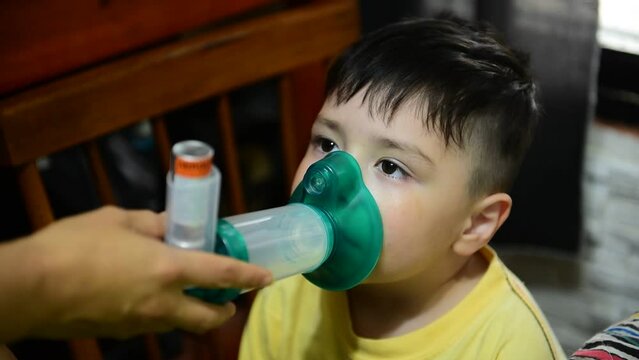 Pneumonia concept. Child using an aerial camera with salbutamol. Asthma concept. Pneumonia concept. Respiratory dilator. Video.