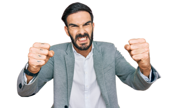 Young hispanic man wearing business clothes angry and mad raising fists frustrated and furious while shouting with anger. rage and aggressive concept.