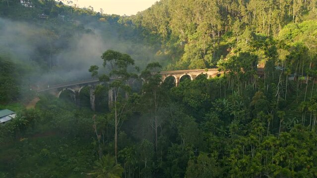Rising Establishing Aerial Drone Shot of Nine Arches Bridge on Sunny and Misty Morning in Ella Sri Lanka