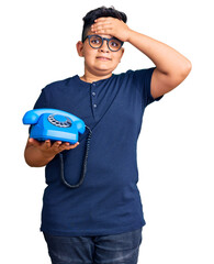 Little boy kid using vintage telephone stressed and frustrated with hand on head, surprised and angry face