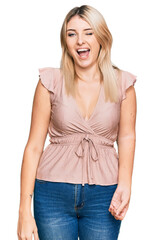 Obraz premium Young caucasian woman wearing casual clothes winking looking at the camera with sexy expression, cheerful and happy face.