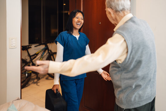 Nurse Arriving At A House To Visiting An Old Man