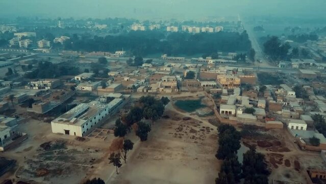 Aerial view of typical Pakistani village in southern Punjab, Multan dry landscape and developments in the rural area. 4k village life in Pakistan. Life of average people in Pakistan. Congested homes. 