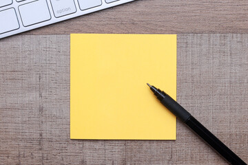 Blank yellow sticky notes over wooden background