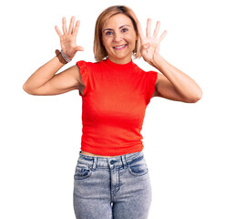 Young blonde woman wearing casual clothes showing and pointing up with fingers number nine while...