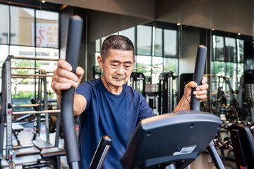 Asian old man in the 70s or 80s to step on flywheel training helping leg muscle strength, Healthy...