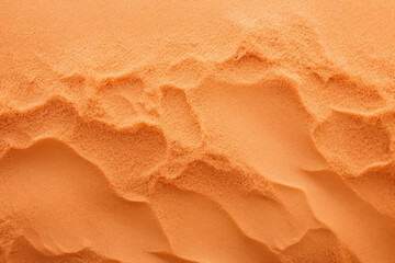 Close up of orange beach sand, exterior surface material texture