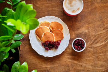 pancakes with cherry sauce. Wooden background, top view.