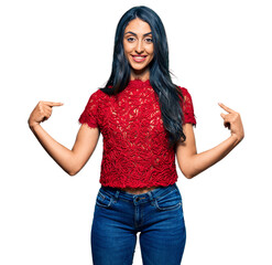 Beautiful hispanic woman wearing elegant shirt looking confident with smile on face, pointing oneself with fingers proud and happy.